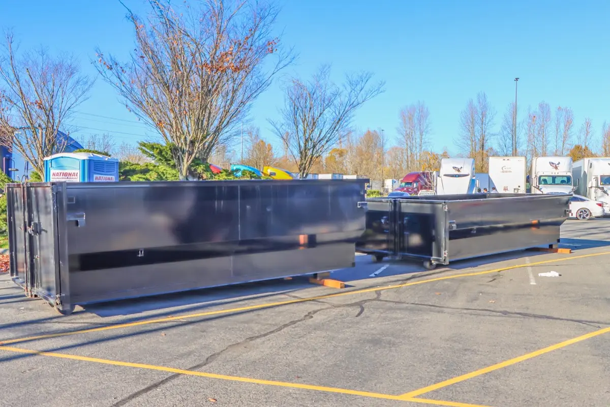 Professional dumpster rental service with roll-off container on residential driveway in Joppatowne